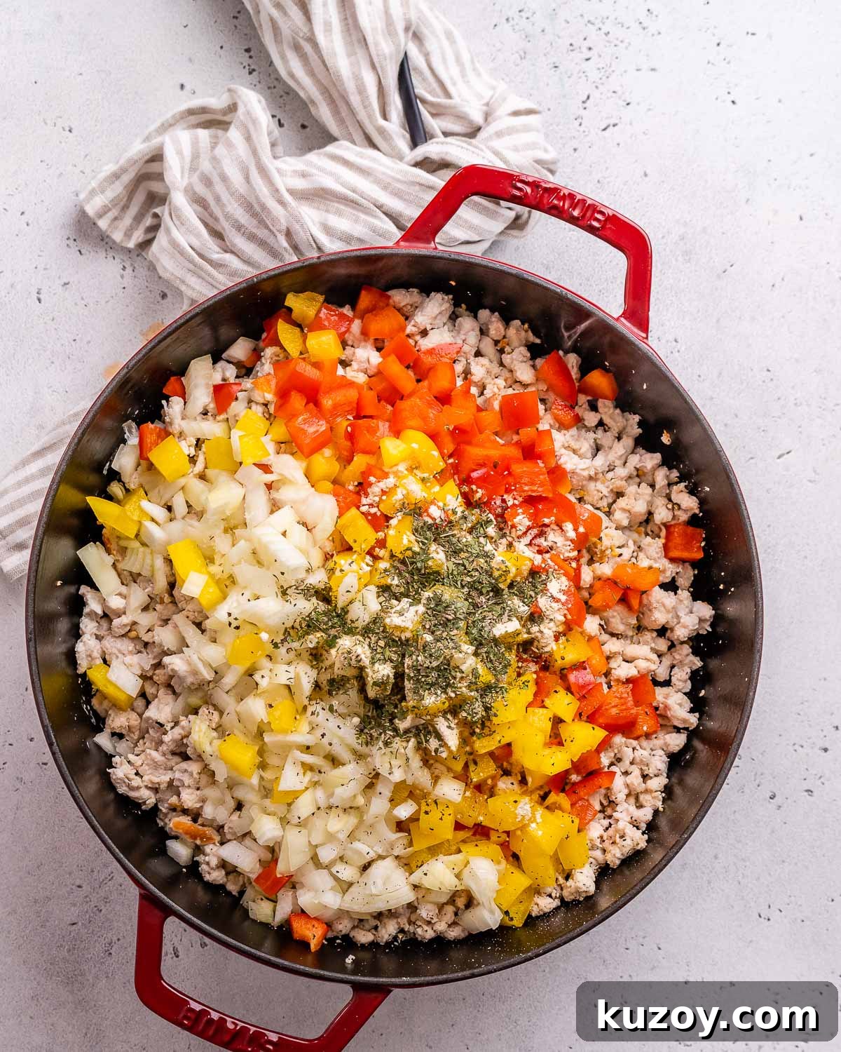 High-Protein Keto Pizza Bowls — Low-Carb Meal Prep 5 Adding vegetables and seasoning to ground meat to make low carb pizza bowls.