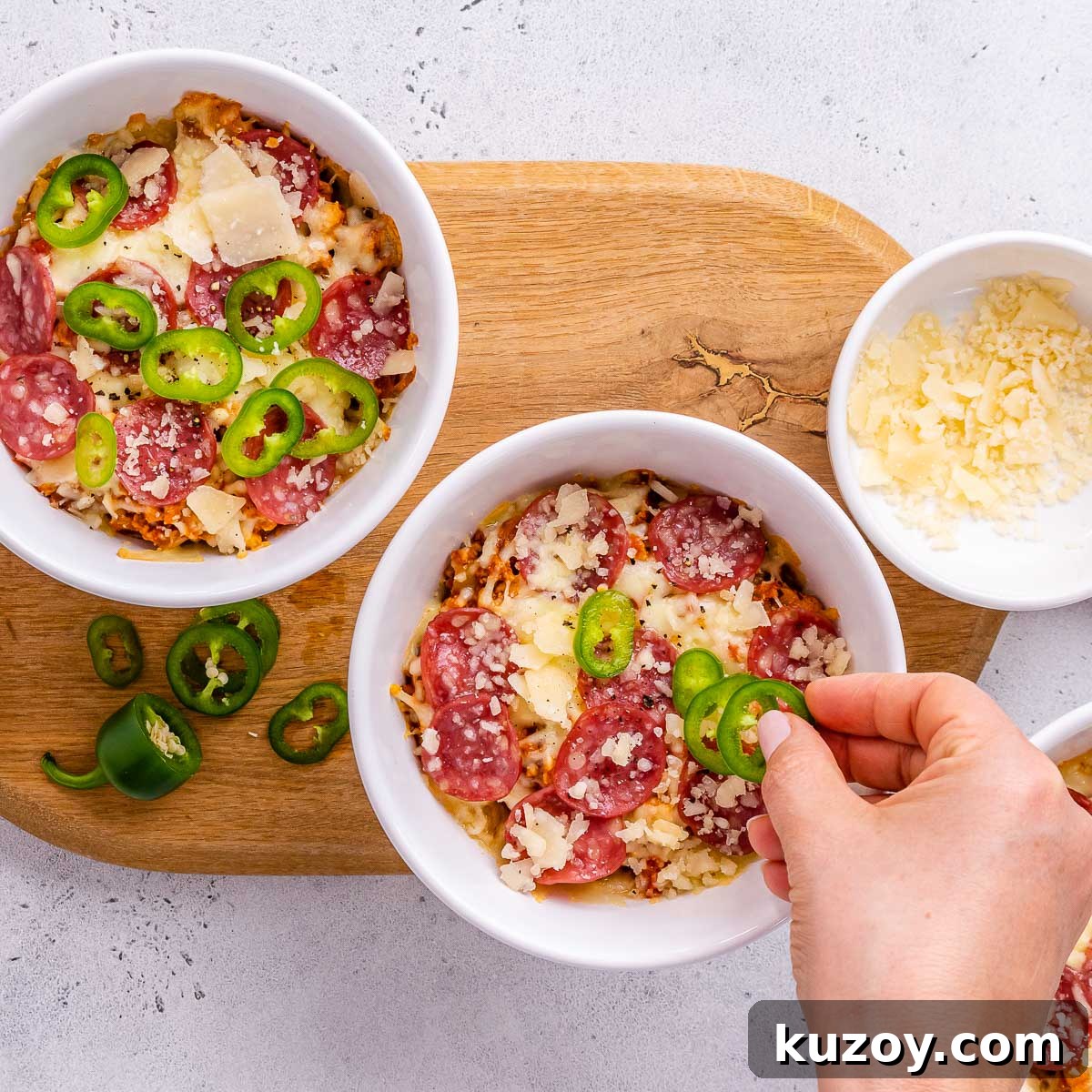 High-Protein Keto Pizza Bowls — Low-Carb Meal Prep 8 Cheese, pepperoni, and jalapenos on pizza bowls.