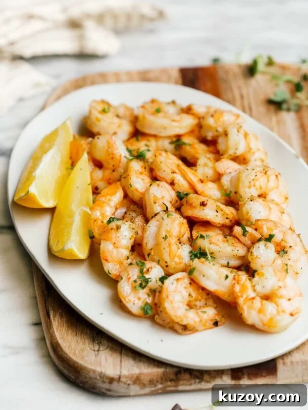 Spicy Cajun Shrimp Skewers with Garlic Butter Dip 7 overhead view of a white plate containing cooked shrimp
