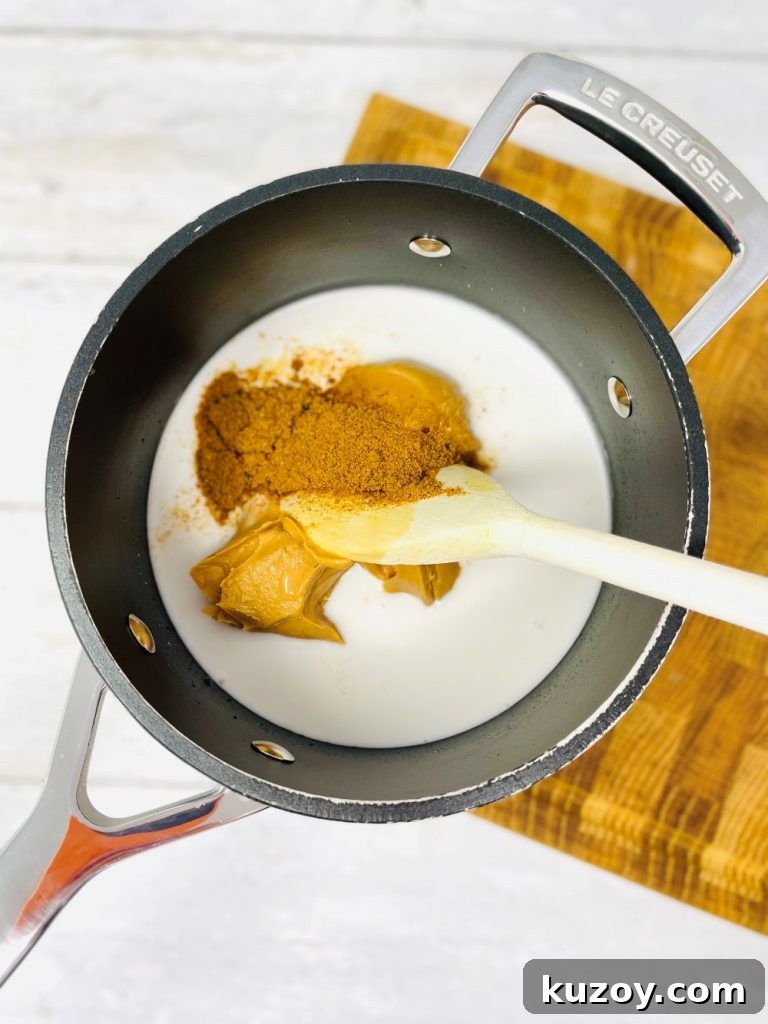 ingredients for satay sauce in a black saucepan