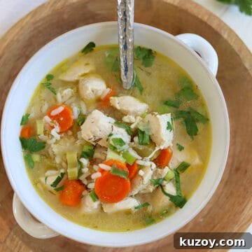 Instant Pot Chicken and Rice Soup Recipe — Comforting Weeknight Meal 6 A white bowl of Instant Pot chicken and rice soup