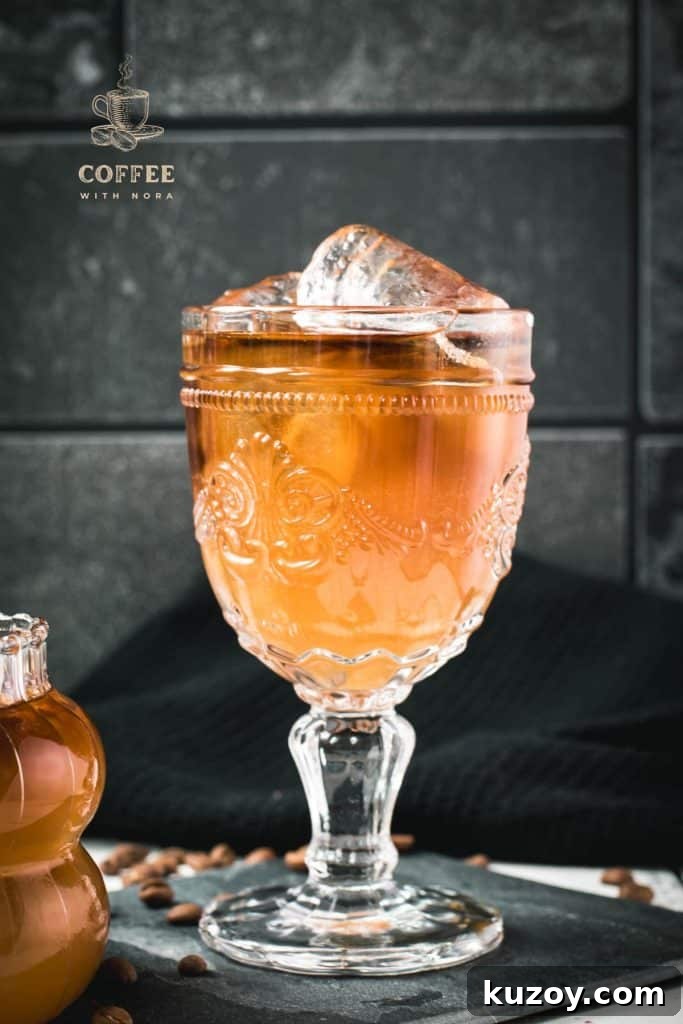 Ginger Cold Brew Recipe: Refreshing Iced Ginger Coffee 2 Glass filled with gorgeous, layered, ginger cold brew placed on black slate plate.