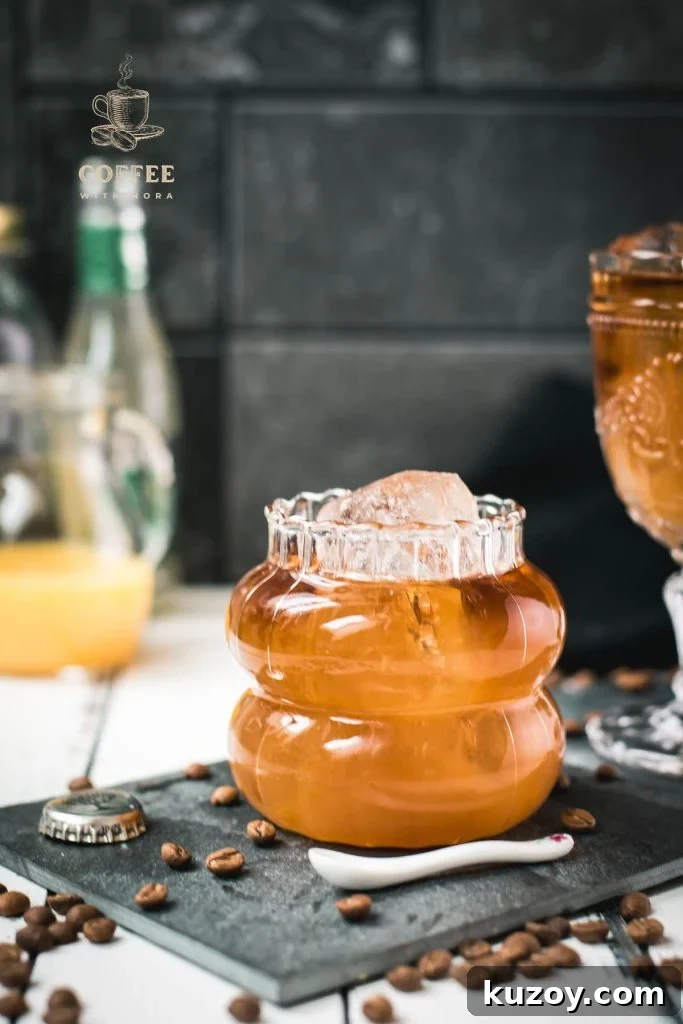 Ginger Cold Brew Recipe: Refreshing Iced Ginger Coffee 7 Glass filled with gorgeous, layered, ginger cold brew placed on black slate plate.