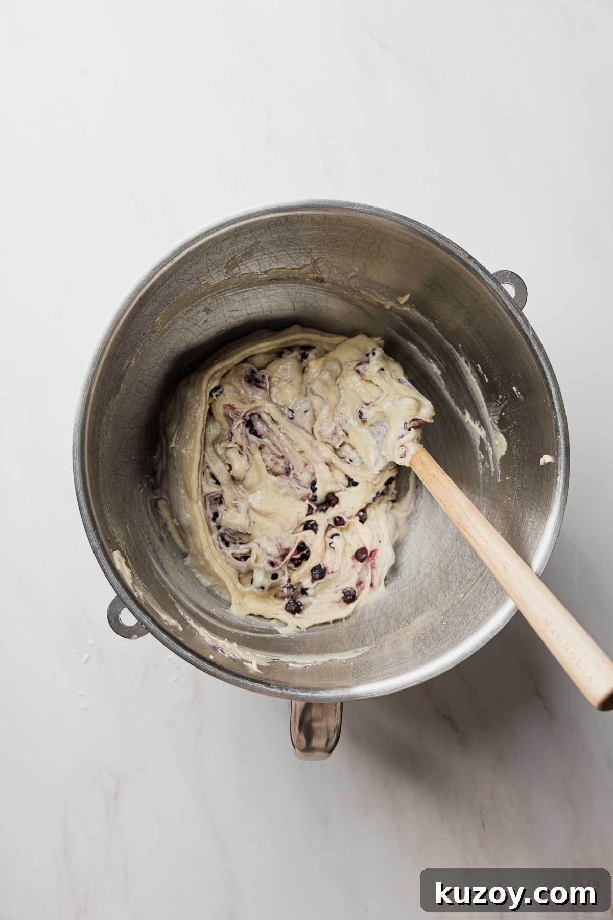 Gluten-Free Blueberry Muffins with Crunchy Streusel Topping 9 Blueberries folded into muffin batter with rubber spatula.