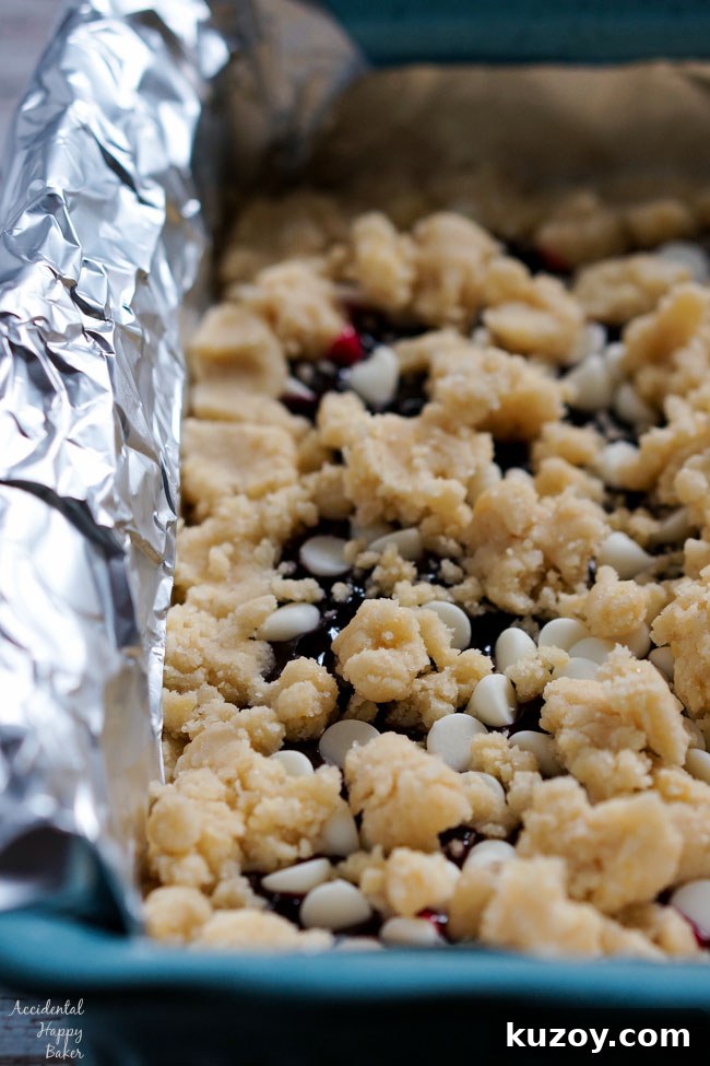 Raspberry and White Chocolate Shortbread Bars Recipe 5 Crumble the remaining shortbread dough over the filling.