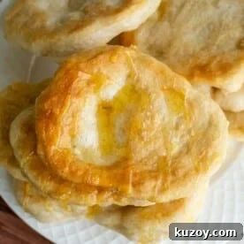 Sourdough Fry Bread sitting on a plate and topped with butter and honey.