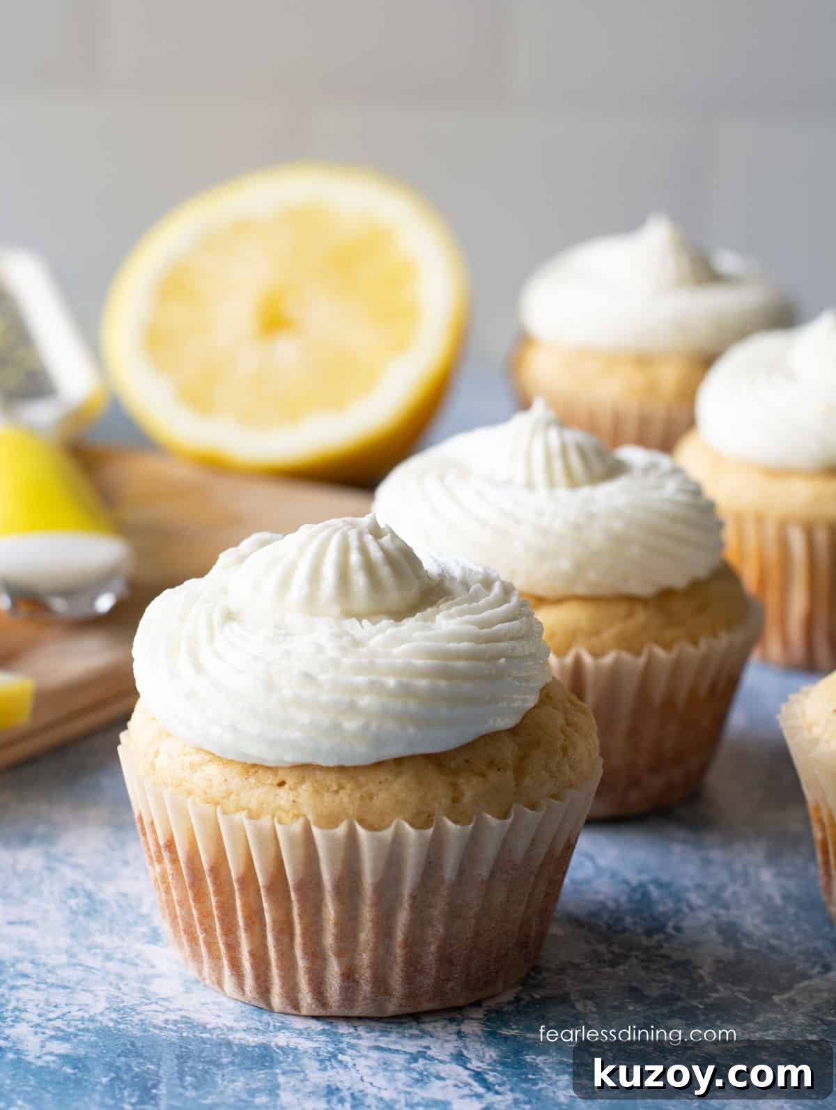 Frosted gluten-free lemon cupcakes made with real lemon juice on a table.