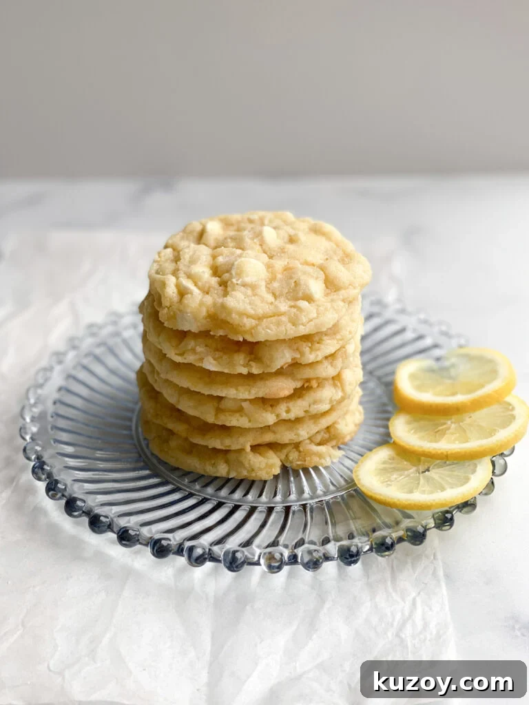 Lemon Coconut White Chocolate Cookie Recipe for Zesty Treats 3 lemon coconut white chocolate cookies on a blue plate with lemon slices