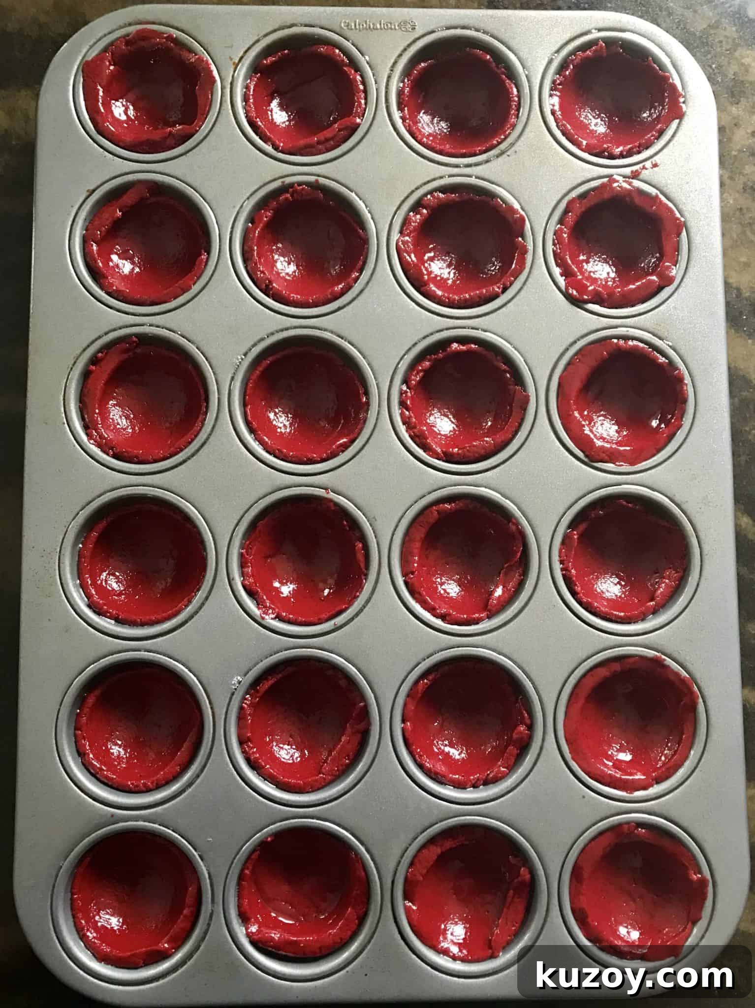 red velvet cake mix balls in mini muffin pan overhead shot ready to be baked