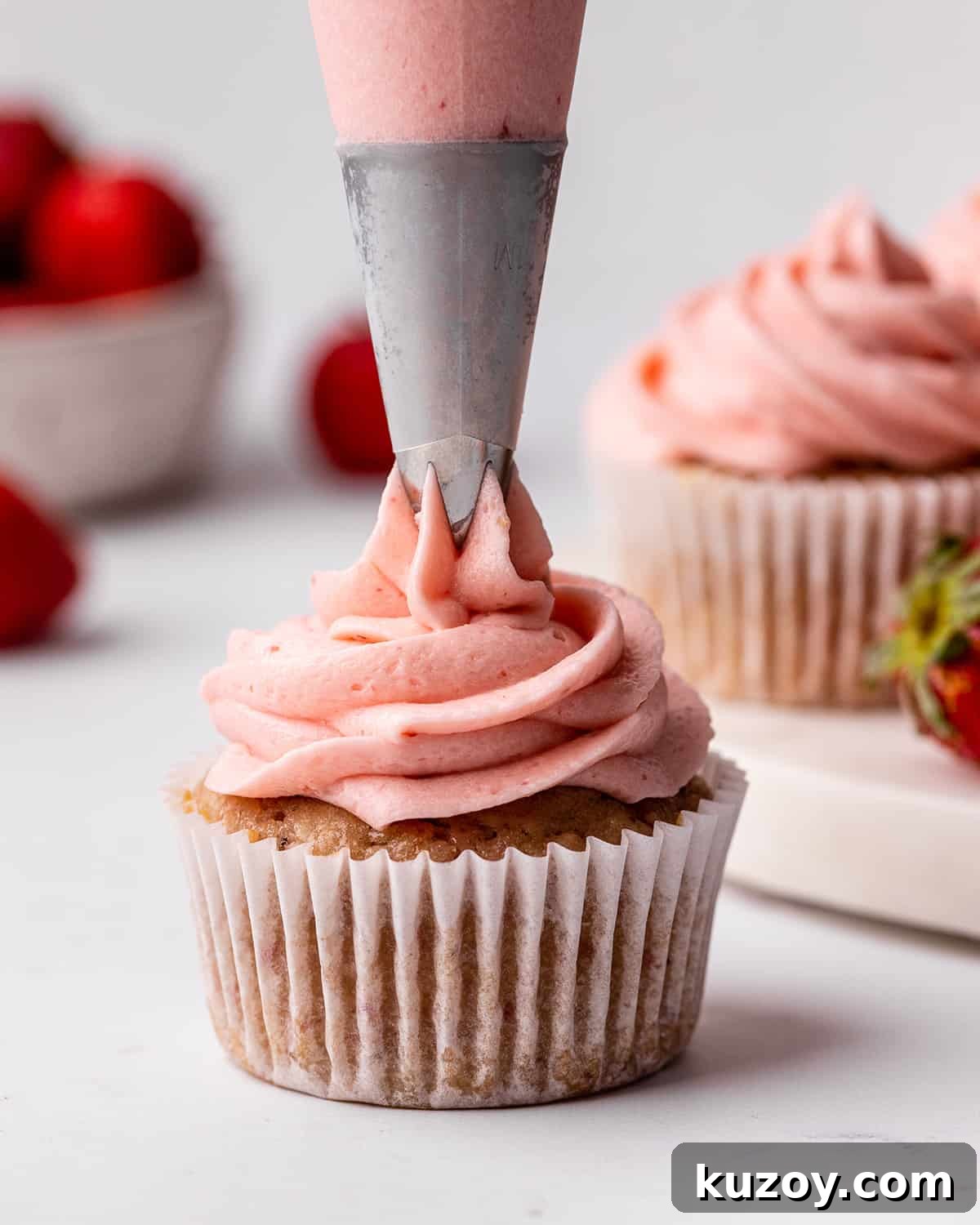 frosting being piped onto a Strawberry Cupcake