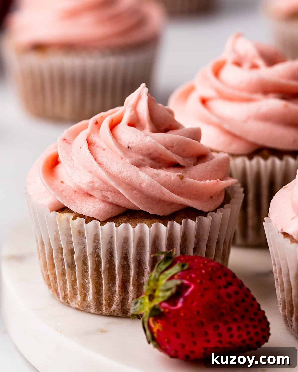 4 frosted Strawberry Cupcakes