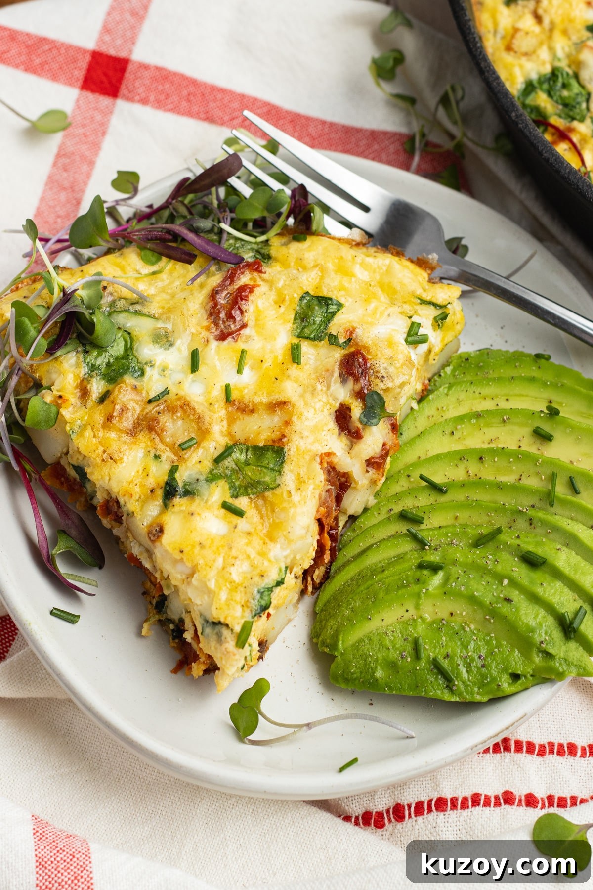 Sun-Dried Tomato and Cottage Cheese Frittata Recipe 14 This is a picture of a slice of frittata with avocado on the side.