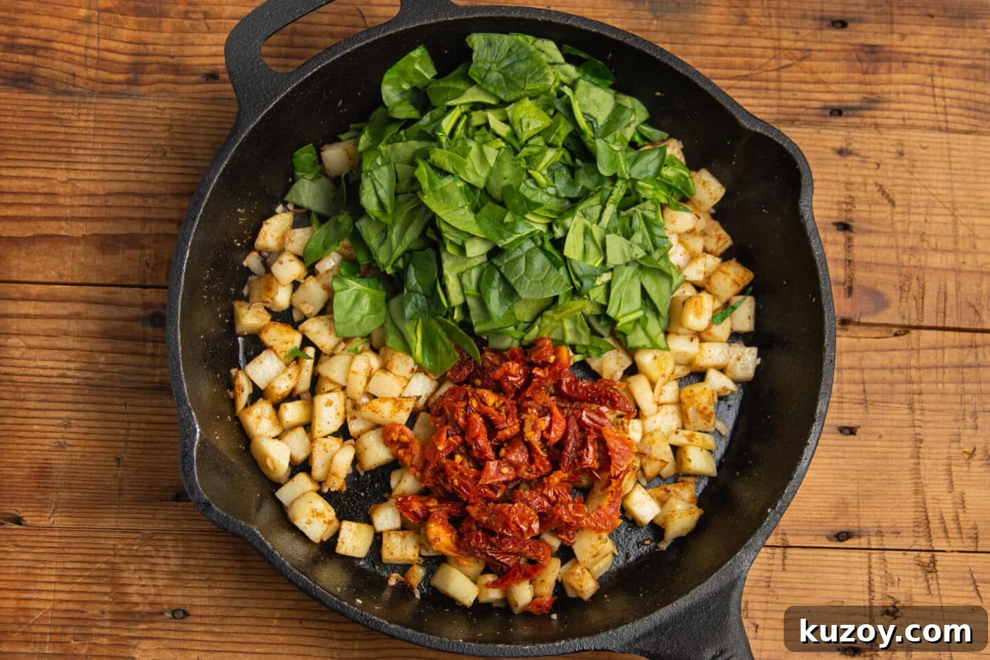 Sun-Dried Tomato and Cottage Cheese Frittata Recipe 9 This is a picture of the skillet with added spinach and sun-dried tomatoes.