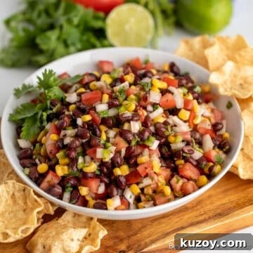 Black Bean Salsa with corn and tomatoes in a white bowl.