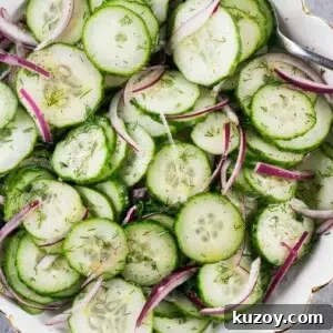 Refreshing Cucumber Salad with Dill and Lemon Vinaigrette 9 close up of sliced cucumbers and red onion in a bowl