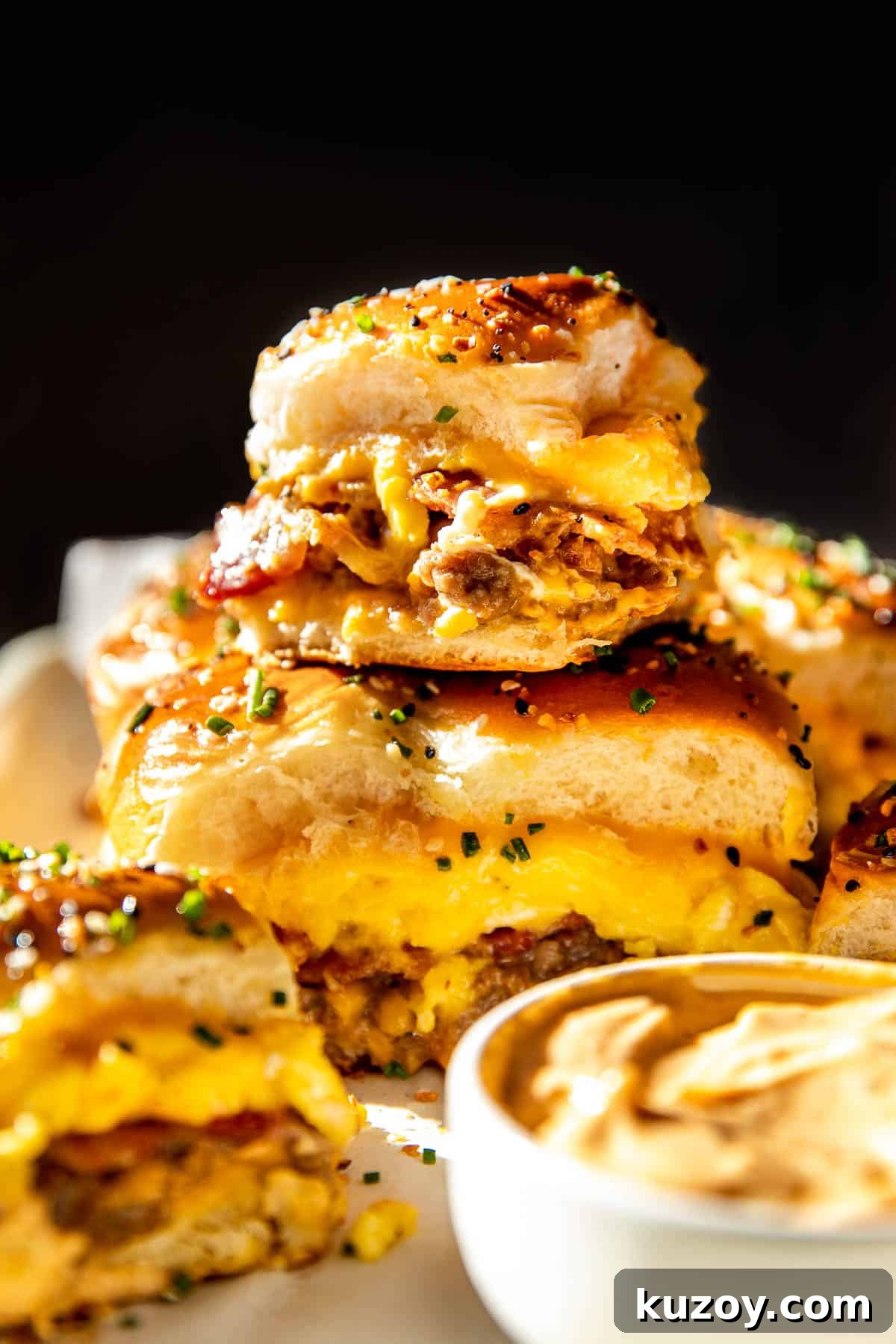 breakfast sliders stacked on top of each other garnished with fresh chives. 
