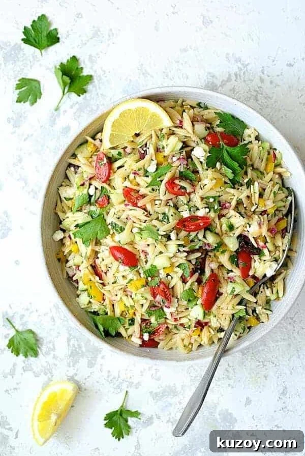 Greek Orzo Pasta Salad in white serving bowl.