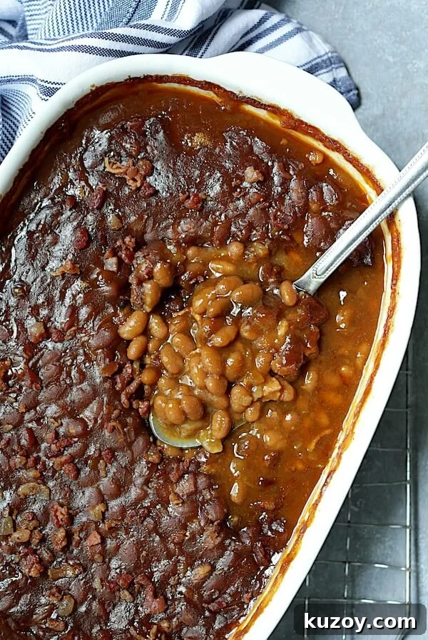 Kicked Up Canned Baked Beans - Overhead shot of the baked beans in white baking dish