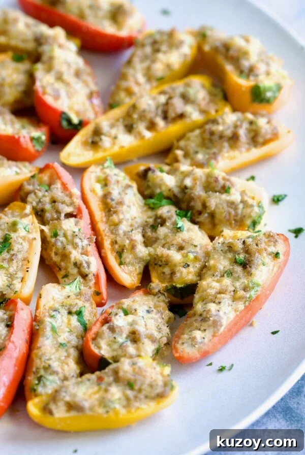 Stuffed Mini Peppers on white oval platter garnished with chopped fresh parsley.