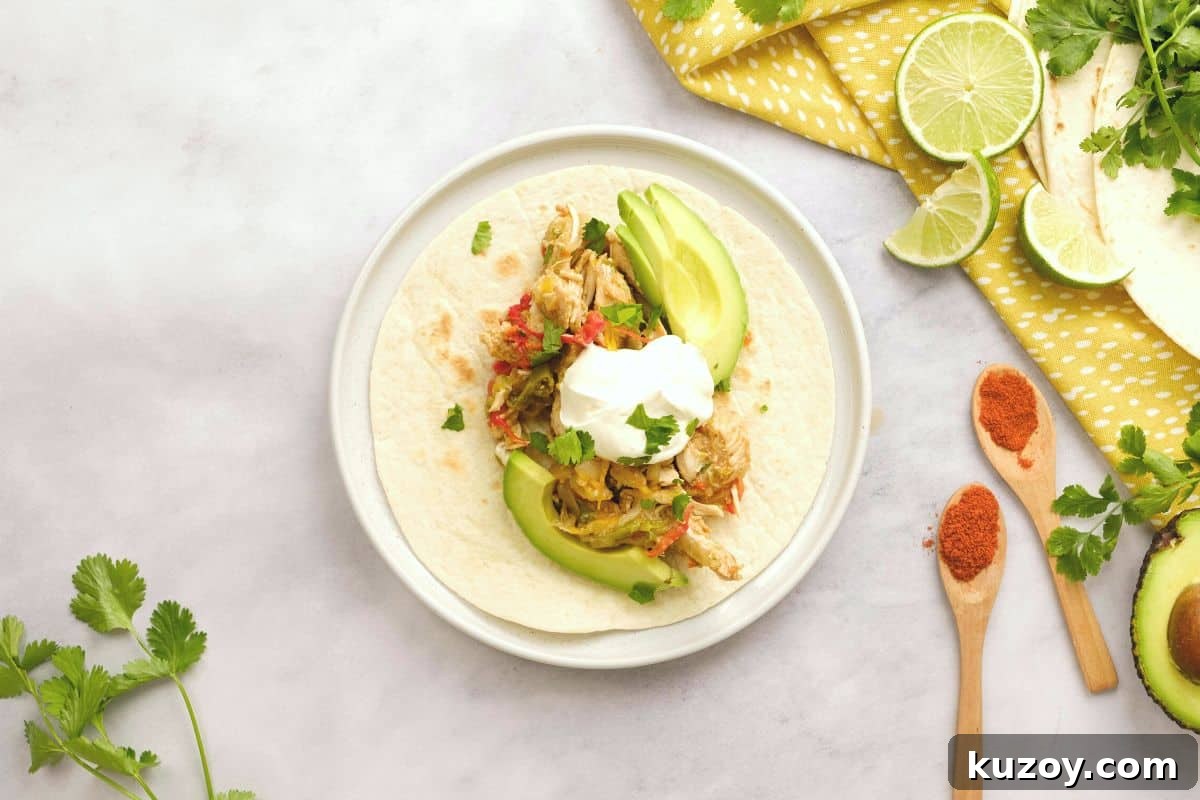 Fajita Insant Pot Recipe Chicken Fajita mixture on flour tortilla topped with sour cream and sliced avocado.