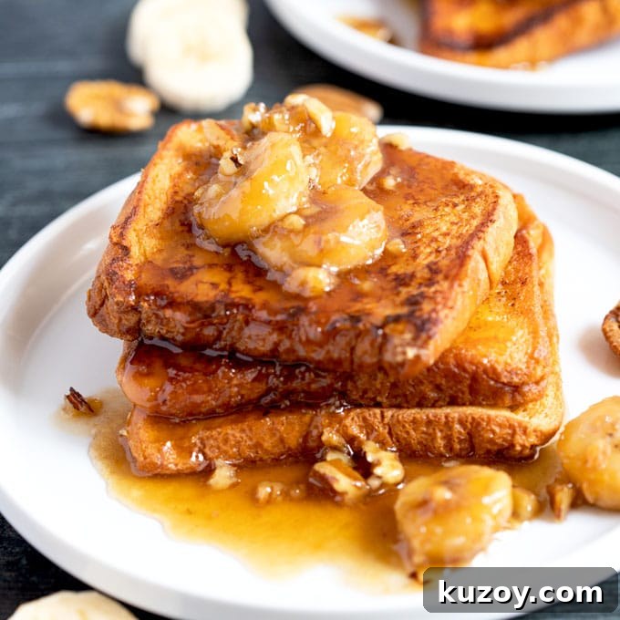 14 Romantic Valentine’s Day Recipes to Make at Home 2 Banana Foster topping served over French toast on a white plate.