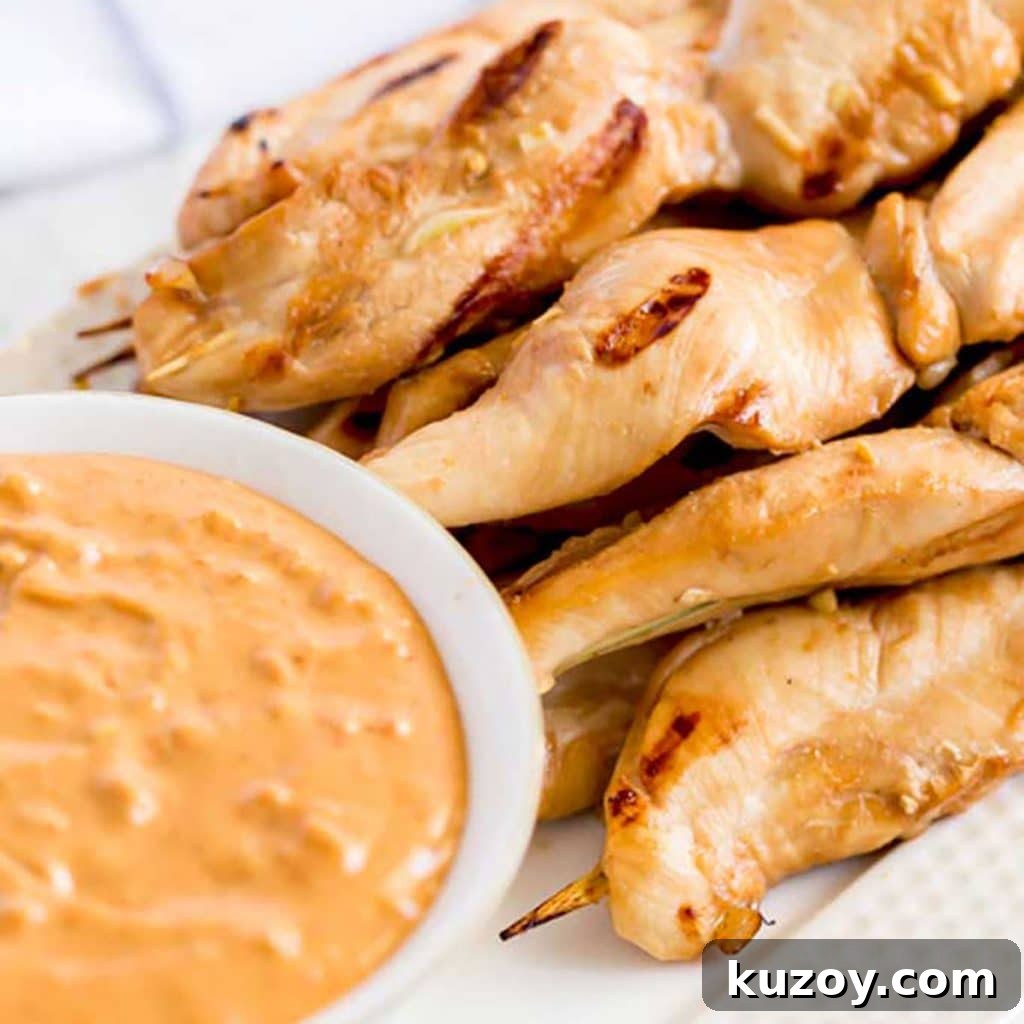 14 Romantic Valentine’s Day Recipes to Make at Home 5 Grilled Chicken Skewers next to a bowl of dipping sauce