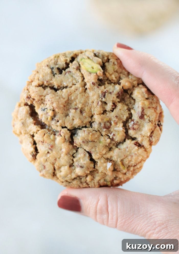 Disney Riviera Signature Cookies: Where to Find & Taste Them 4 hand holding Disney cookie