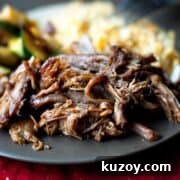 Easy Blackberry BBQ Pulled Pork on a black plate.