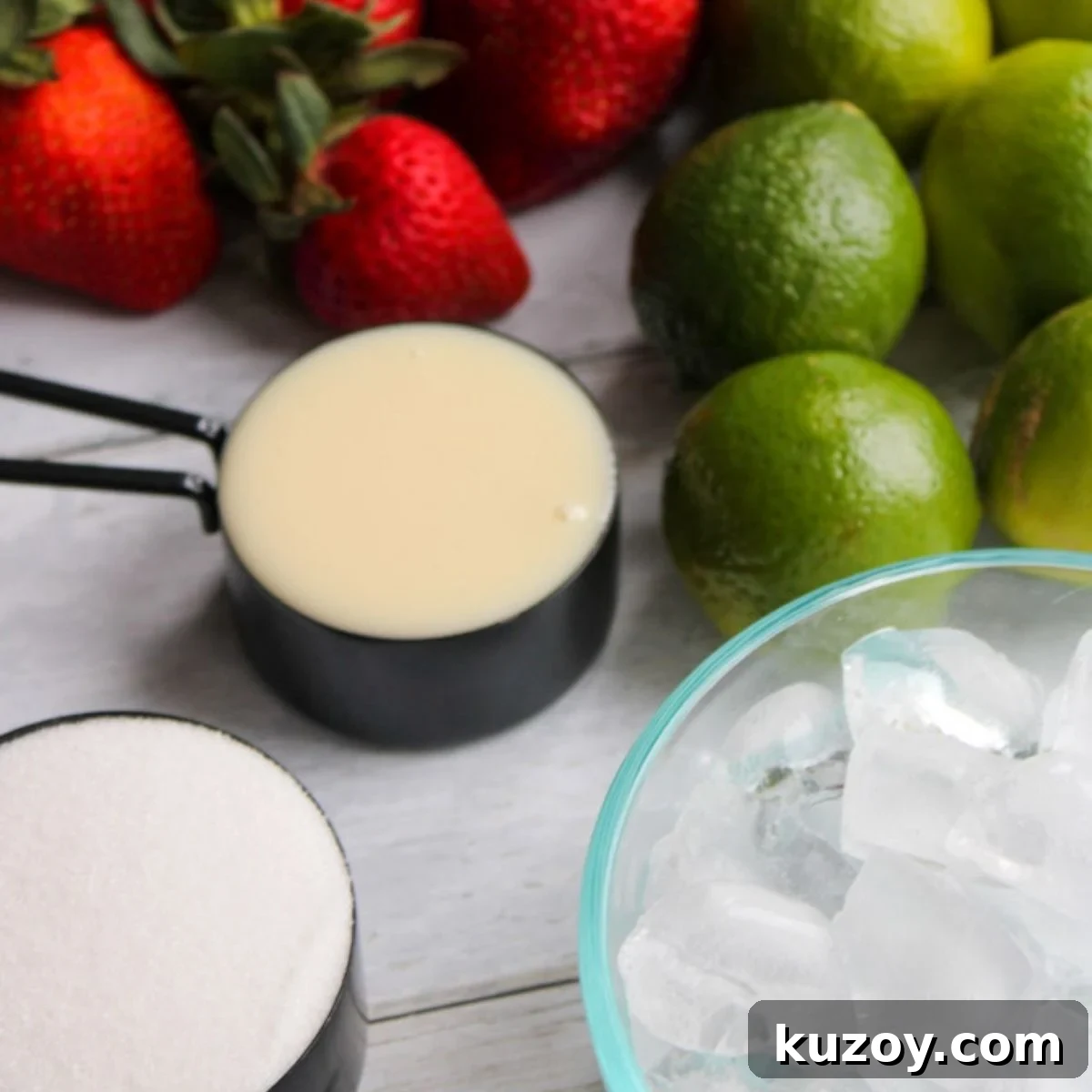 Strawberries, limes, sweetened condensed milk, sugar, and ice for Brazilian strawberry limeades.