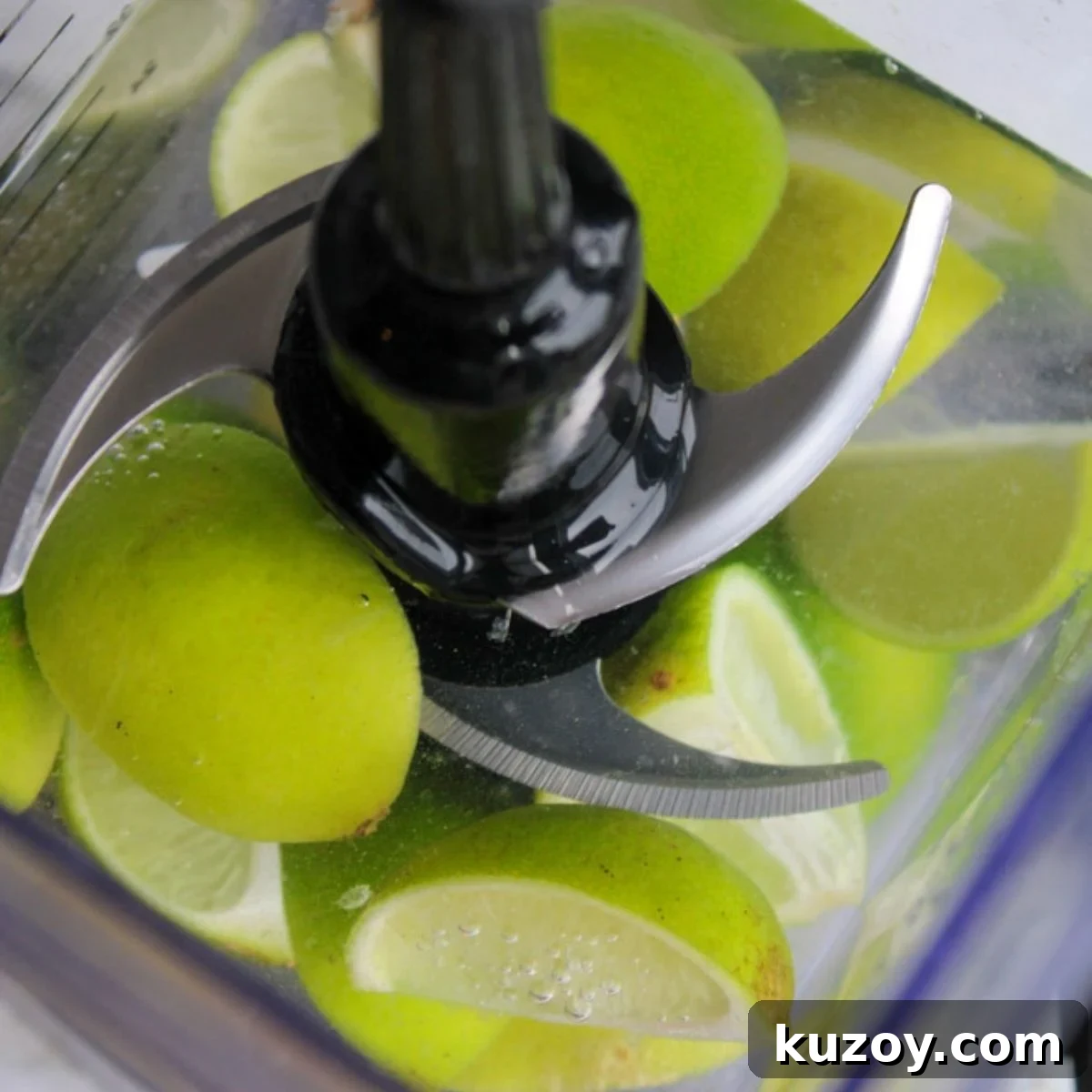 Limes and water in a blender.