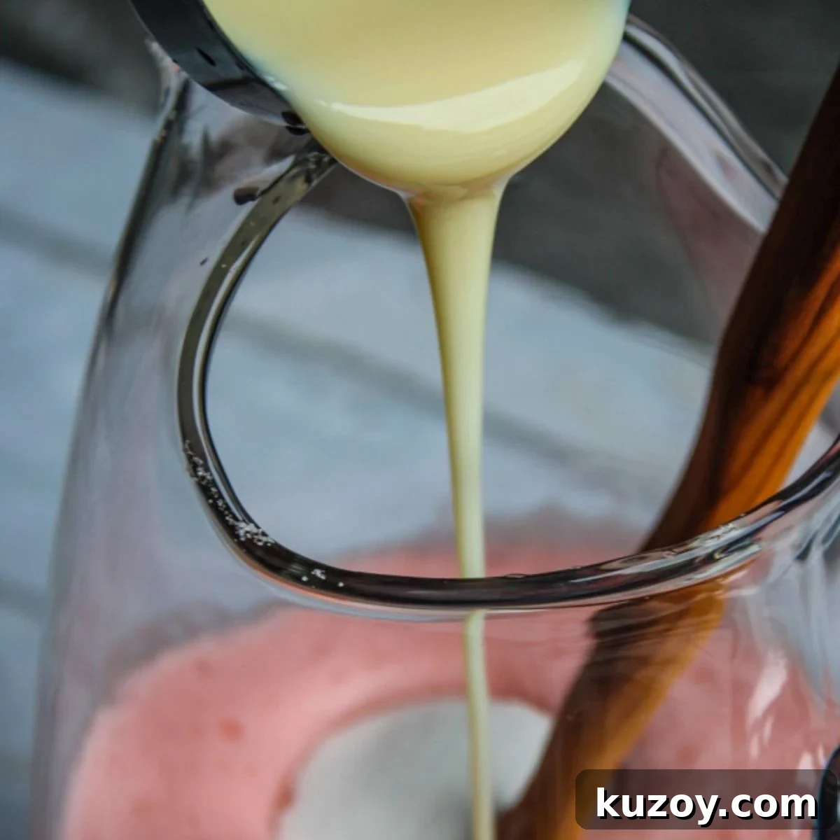 Adding sweetened condensed milk and sugar to make Brazilian limeade.