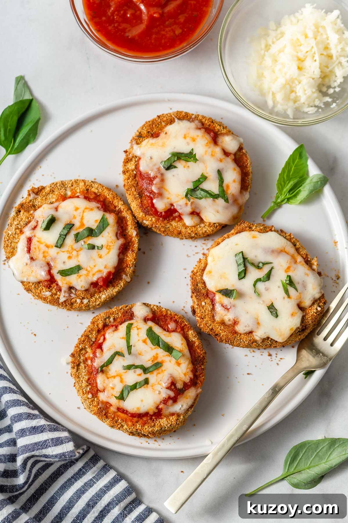 Crispy Air Fryer Eggplant Parmesan Recipe 2 air fryer eggplant parmesan on a plate.