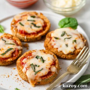 Crispy Air Fryer Eggplant Parmesan Recipe 15 air fryer eggplant parmesan on a plate with a fork.