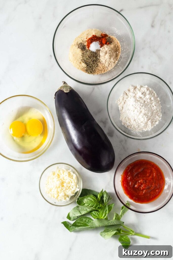 Crispy Air Fryer Eggplant Parmesan Recipe 3 Eggplant parmesan ingredients on a marble counter.