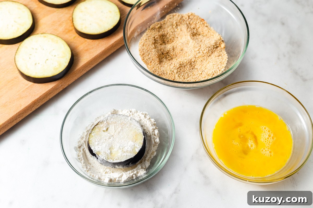 Crispy Air Fryer Eggplant Parmesan Recipe 7 eggplant dipped in flour.
