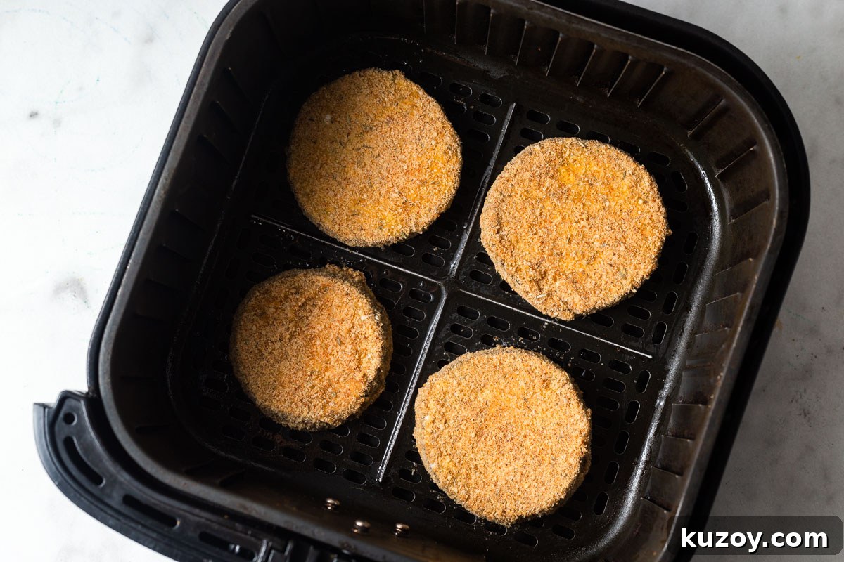 Crispy Air Fryer Eggplant Parmesan Recipe 10 breaded eggplants in the air fryer basket.