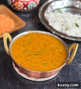 One Pot Masoor dal - Red lentil curry served in a copper pot with rice and spices.