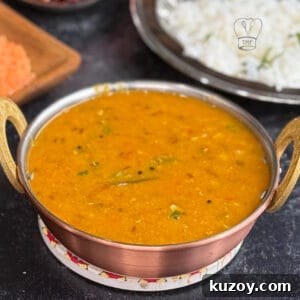 Red lentil curry served in a copper bowl, highlighting vibrant orange color and rich texture.