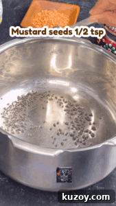 Mustard and cumin seeds spluttering in hot ghee