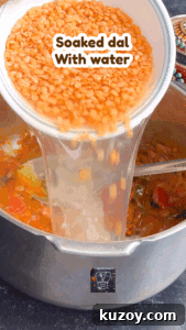 Soaked red lentils in water for making flavorful dal or lentil curry.