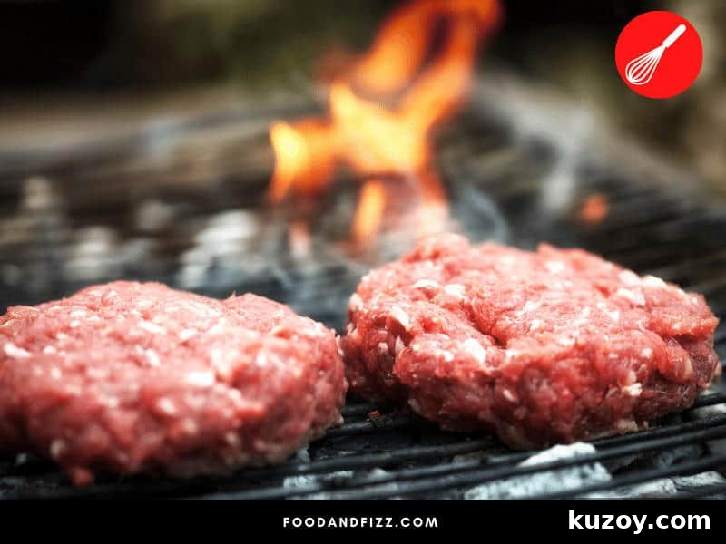 Is a Pink Center in Burgers Safe to Eat? Expert Answer 3 Uncooked burger patties will always be red or pink because of what's called myoglobin. When exposed to high heat, a chemical reaction occurs causing your burgers to turn brown as it cooks.