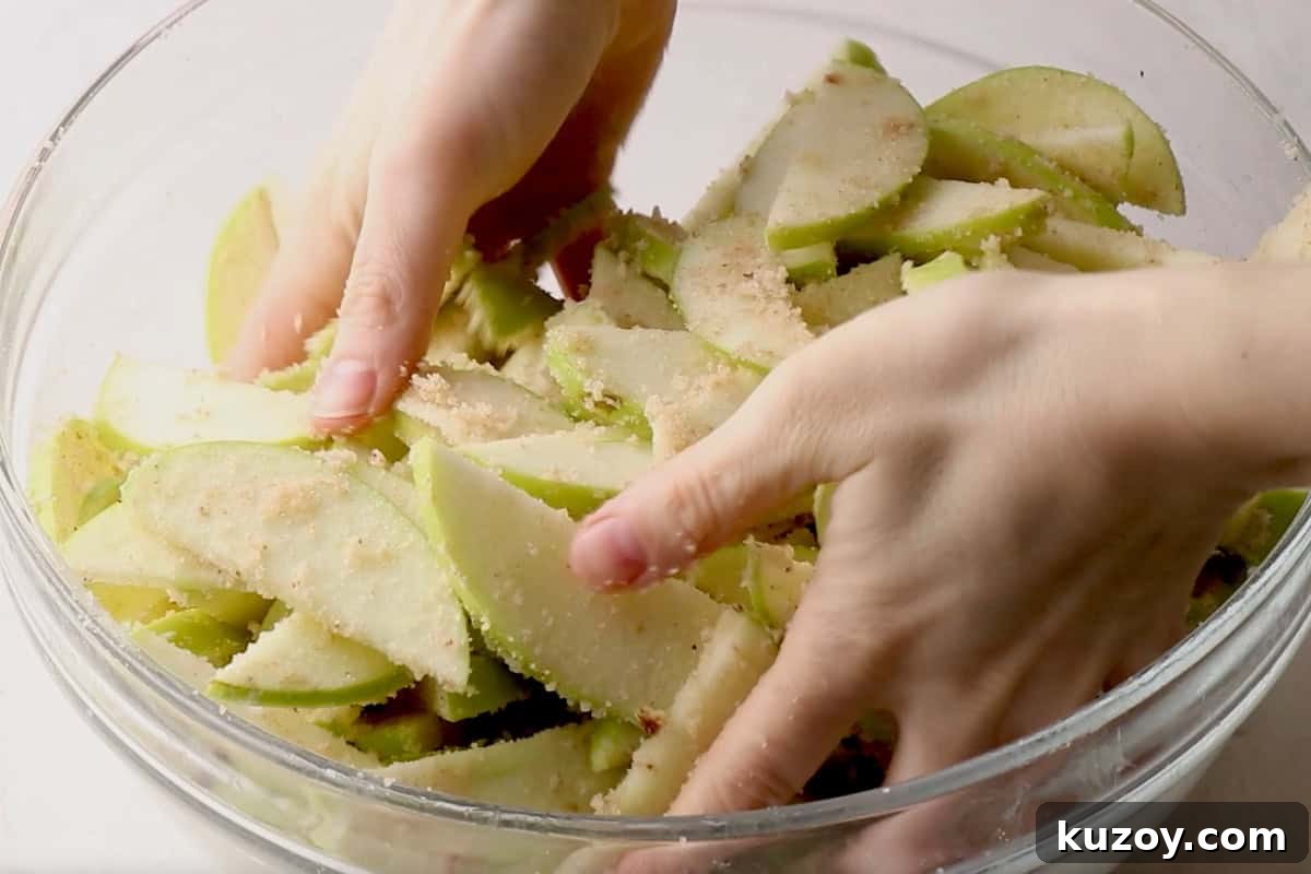 Classic Homemade Apple Pie Recipe for Perfect Crust and Filling 6 tossing green apple slices with spiced butter and sugar.