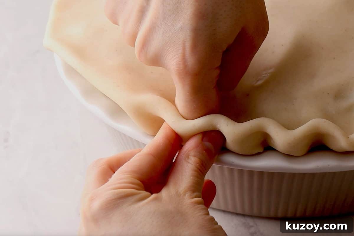 Classic Homemade Apple Pie Recipe for Perfect Crust and Filling 8 crimping pie crust edges.