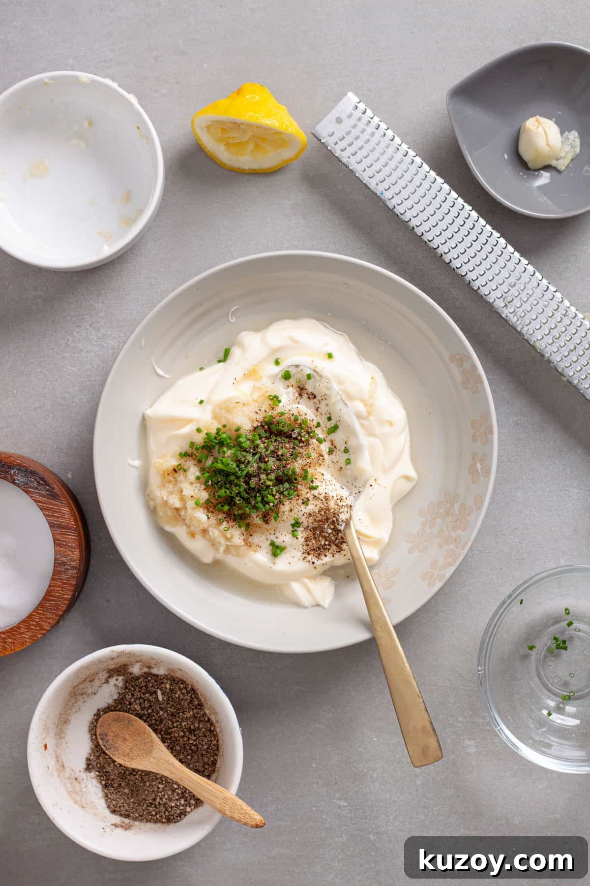 A small mixing bowl with ingredients for a horseradish aioli.