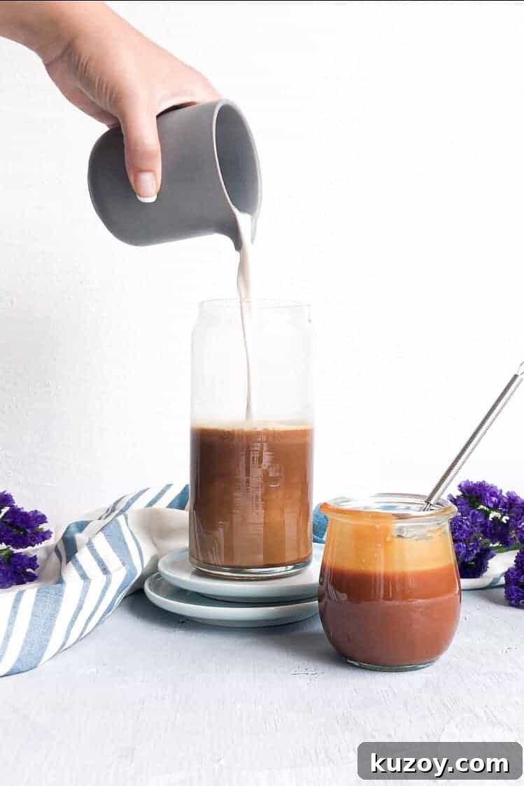 Cream pouring into a caramel coffee