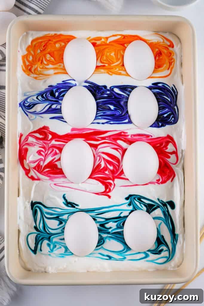 Vibrant Easter Eggs Dyed with Cool Whip: Step-by-Step Guide 6 eggs placed on the food dye swirls
