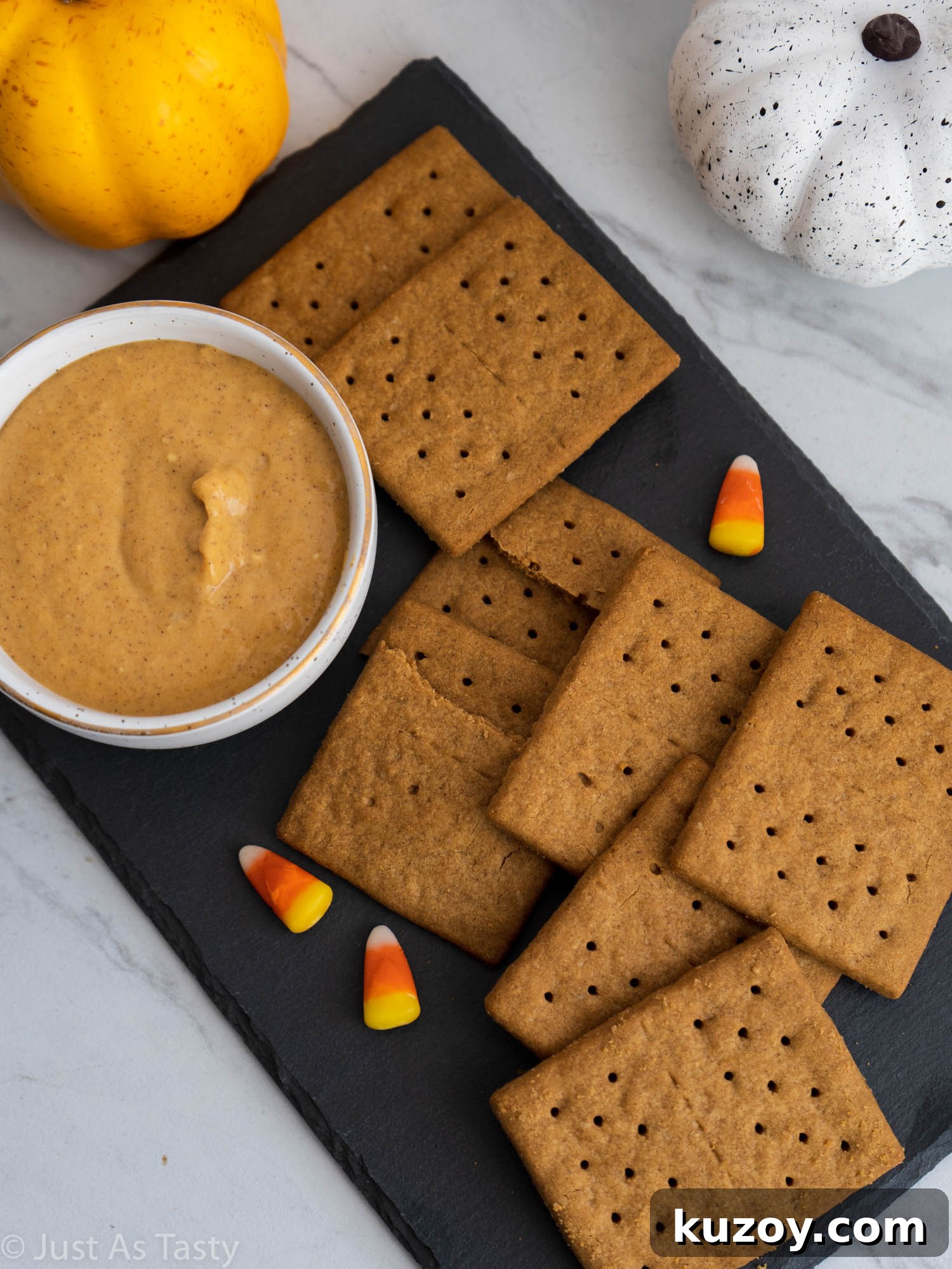 Creamy Pumpkin and Cream Cheese Dip Recipe for Fall Parties 3 Pumpkin dip in a white bowl surrounded by graham crackers.