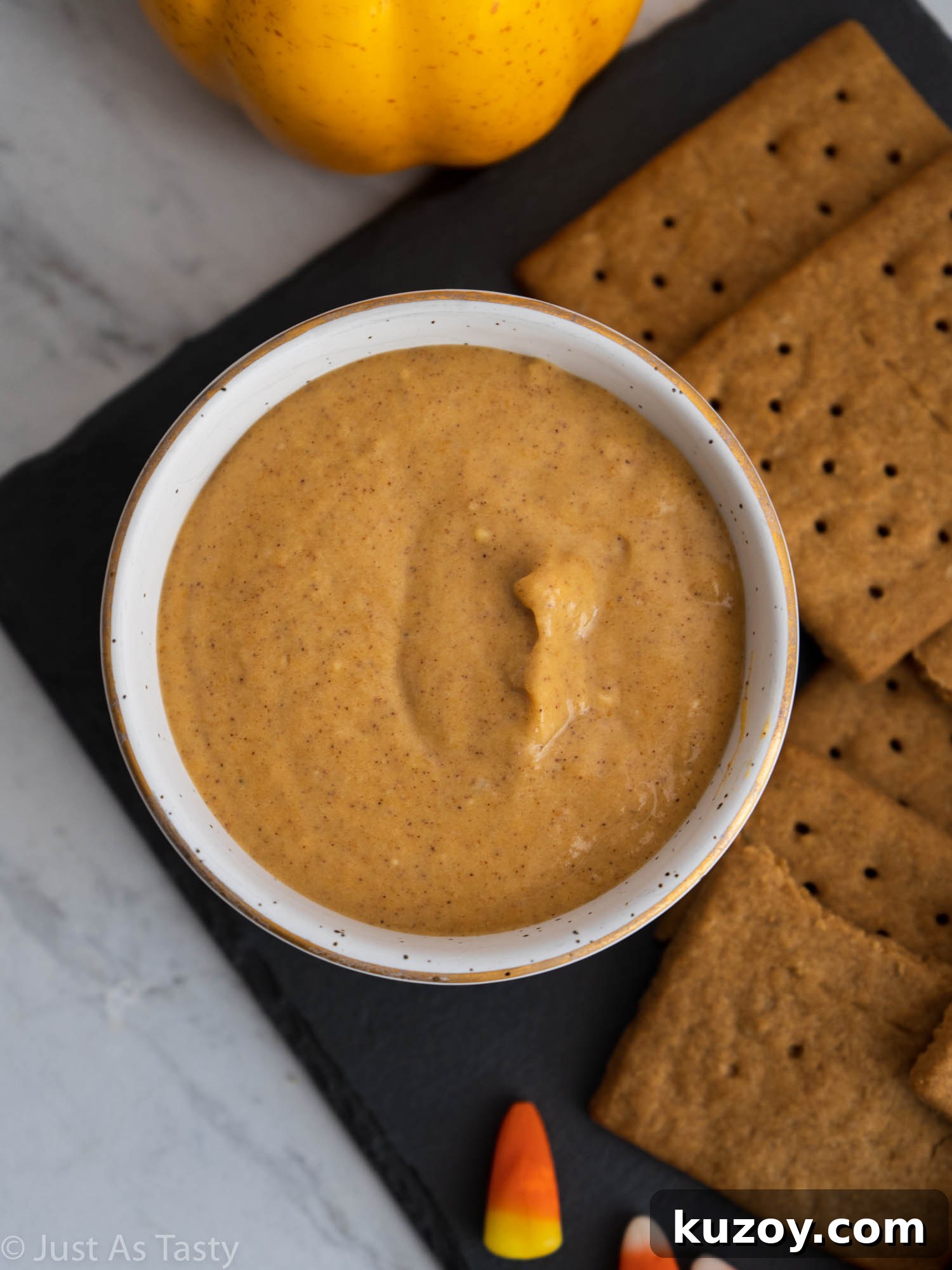 Creamy Pumpkin and Cream Cheese Dip Recipe for Fall Parties 4 Close-up of pumpkin dip in a white bowl.