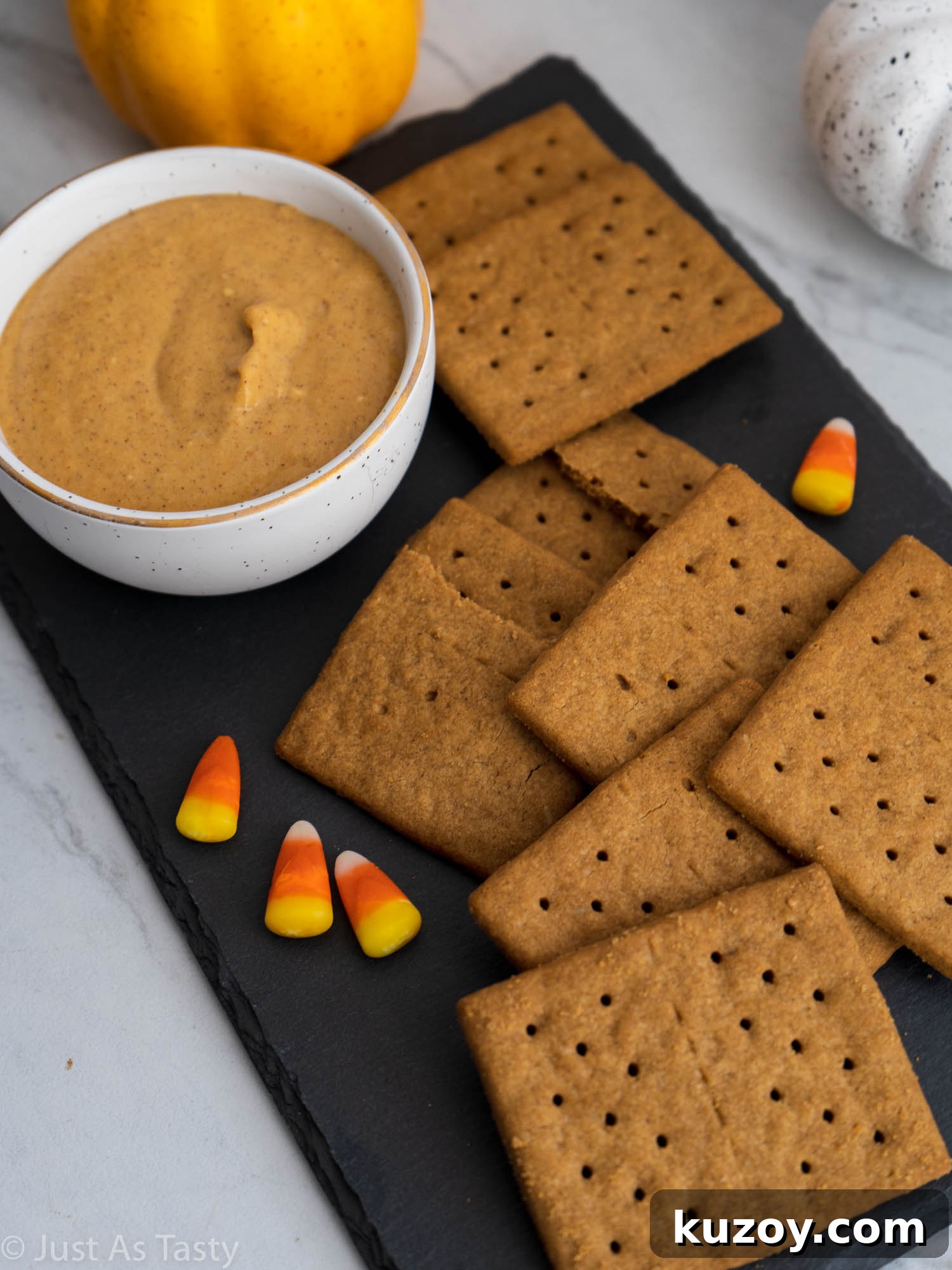 Creamy Pumpkin and Cream Cheese Dip Recipe for Fall Parties 5 Gluten free graham crackers and candy corn alongside pumpkin cream cheese dip.