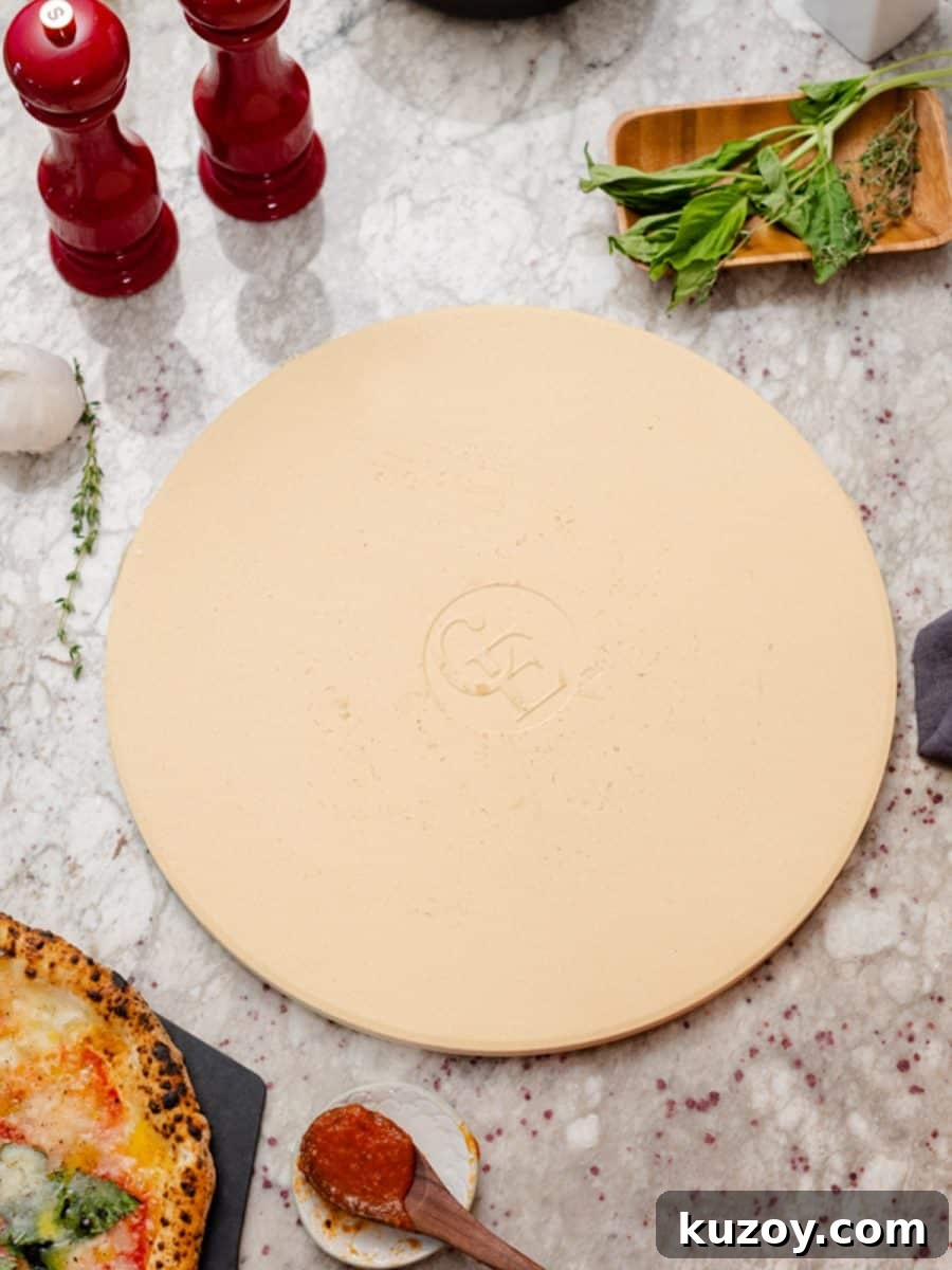 Pizza stone with salt and pepper shaker and marinara sauce on spoon